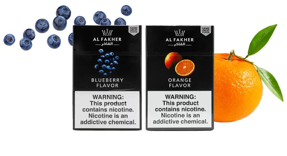 Al Fakher Blueberry and Al Fakher Orange 50g boxes with blueberries and an orange