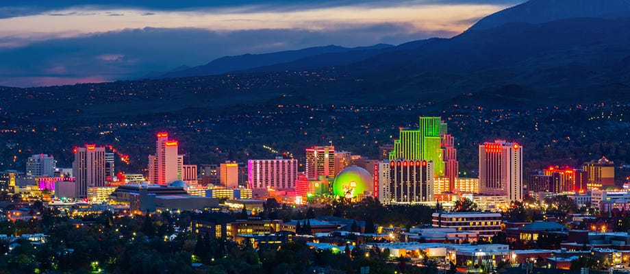 Nevada Las Vegas Strip at night against mountains at sunset