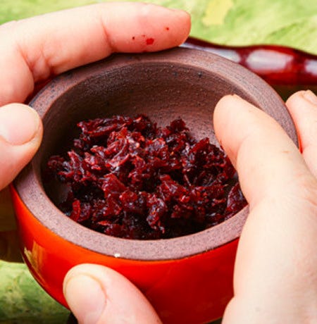 A red hookah bowl filled with shisha