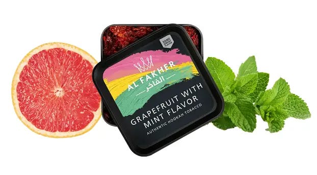 Jar of Al Fakher Grapefruit Mint next to sliced grapefruit and mint leaves