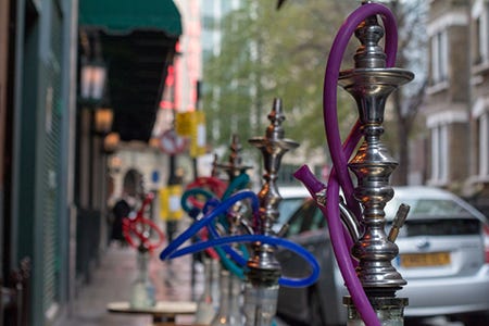 Street view of hookahs outside hookah shop